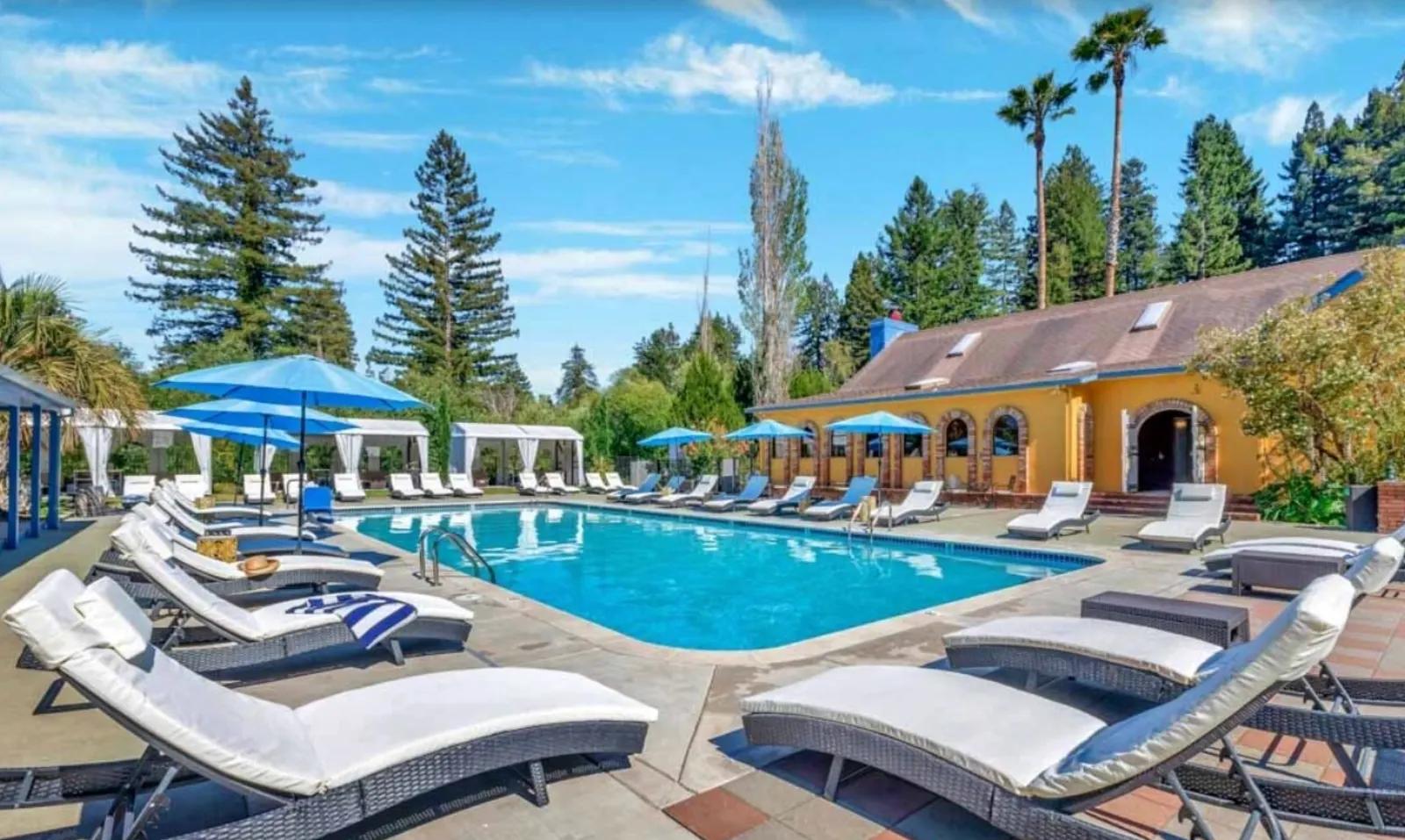 Resort pool with loungers and cabanas at a glamping resort