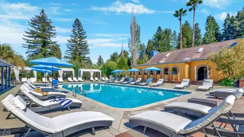 Resort pool with loungers and cabanas at a glamping resort