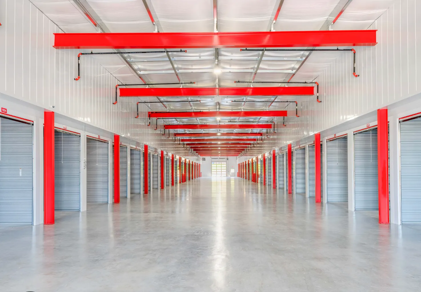 Corridor of closed self storage unit doors in a multi-storey facility
