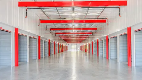 Corridor of closed self storage unit doors in a multi-storey facility