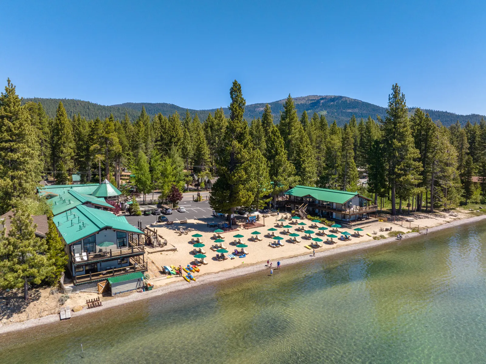 Lakeshore resort with a beach on a forested mountain lake