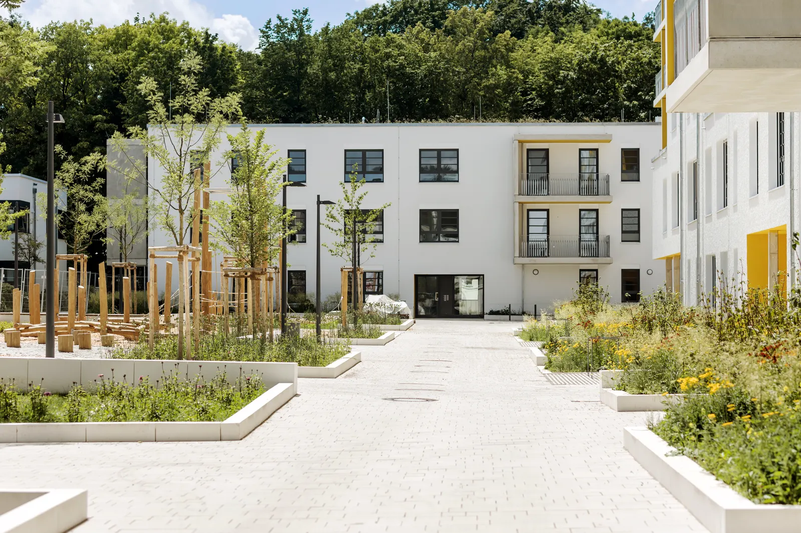 Three-storey senior living building with landscaped courtyard and accessible entry