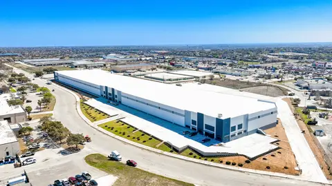 Aerial view of a modern industrial warehouse facility showing dock-high doors, truck court depth, and site circulation layout critical to last-mile logistics planning.