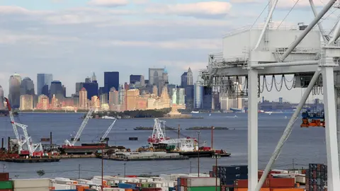Active waterfront port with cargo infrastructure and urban skyline, representing the multilayered federal, state, and municipal permitting complexity facing U.S. marina and waterfront development.