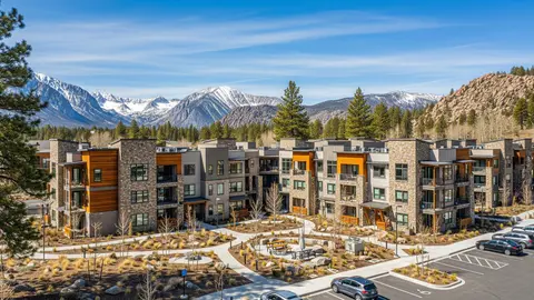Modern mountain multifamily complex showcasing sustainable architecture and outdoor community design, representing trends discussed in the Multifamily Development Outlook 2025.

