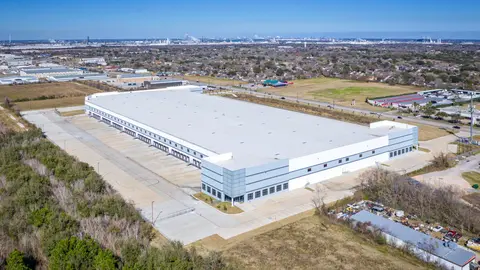 Large-scale industrial distribution facility in the Houston metro area illustrating how stormwater detention requirements and impervious surface constraints shape site layout, building footprint, and remaining developable acreage on greenfield commercial parcels.