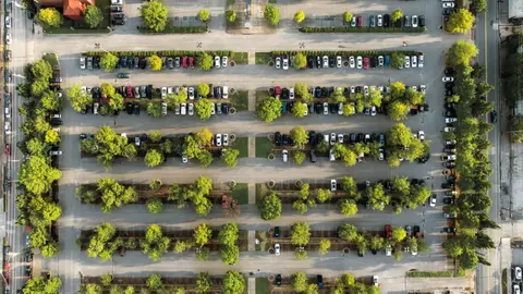 Aerial view of surface parking bays and landscaped rows on a commercial site