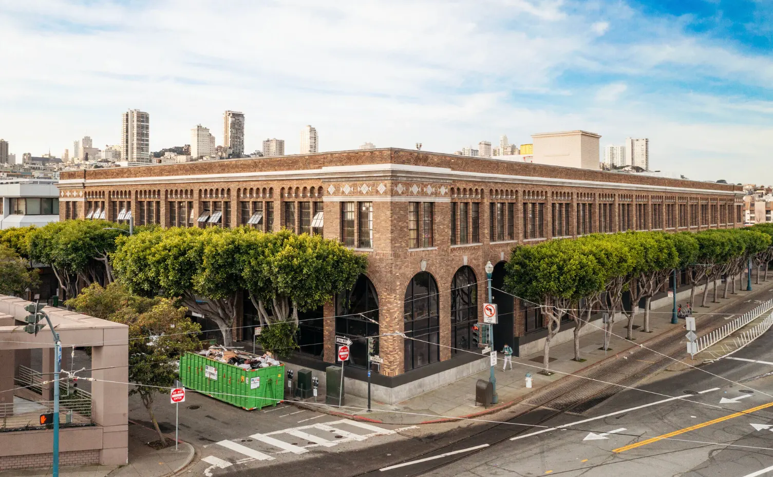 Historic low-rise brick commercial building in San Francisco occupying a full city block, illustrating sub-1.0 FAR development in a high-density urban market where zoning reform and the 2025 Family Zoning Plan are reshaping allowable density limits.