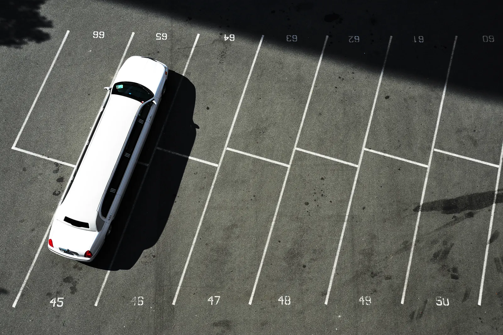 Overhead view of a largely empty numbered surface parking lot